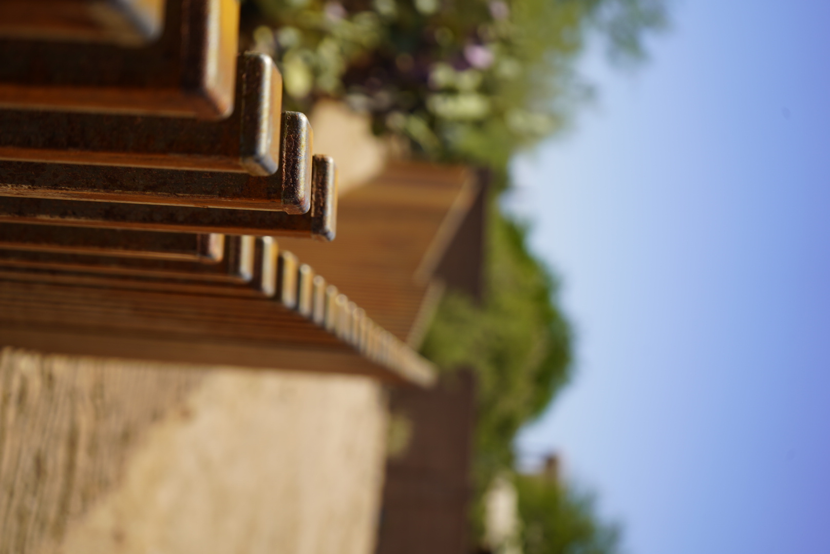 Custom rusted steel fence with square tube posts along a desert property in Marana, Arizona